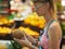 Girl picks coconuts at a grocery store.