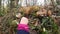 The girl picks and touches the wild forest chives allium schoenoprasum in forest