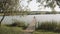 Girl on the pier on the lake fishing