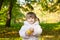 Girl with pigtails holding fruit