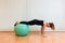Girl pilates trainer does plank fitball basic posture in fitness center