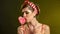 Girl in pin-up style lick striped lollipops.