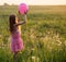 girl with pink balloon outdoor