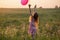 girl with pink balloon outdoor