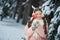 Girl in pink coat in snow Park. Girl plays in winter Park. Adorable child walking in snow winter forest