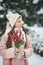 Girl in pink coat in snow Park. Girl plays in winter Park. Adorable child walking in snow winter forest