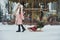 Girl in pink coat in snow Park. Girl plays in winter Park. Adorable child walking in snow winter forest