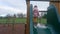 Girl in pink coat standing on a climbing frame