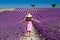 Girl in pink dress walking in lavender field