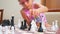 Girl in pink frame glasses plays chess