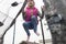 Girl in pink hats and jackets jumps on a trampoline. Street lighting. Close-up