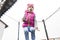 Girl in pink hats and jackets jumps on a trampoline. Street lighting. Close-up