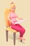 Girl in pink reading a newspaper sitting on a chair, isolated. Reading news 3d-rendering