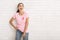 Girl In Pink Ribbon T-Shirt Laughing Standing Near White Wall