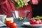 Girl in a pink shirt puts a fresh salad in a transparent bowl