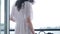 girl in pink silk robe stands on the balcony and dances