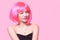 The girl in a pink wig, on a pink background, is happy, grimaces, smiles. Bright photo of a teenager, smart, party, dance. Anime