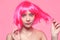 The girl in a pink wig, on a pink background, is happy, grimaces, smiles. Bright photo of a teenager, smart, party, dance. Anime