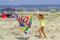 Girl play with colorful sailing ship kite