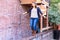 Girl Playing and Balancing on Red Brick Wall