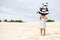 Girl playing on beach flying ship kite. Child enjoying summer.