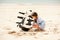 Girl playing on beach flying ship kite. Child enjoying summer.