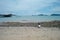 Girl playing on the beach with horizontal skyline of seascape in