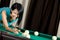 Girl playing billiard