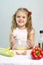 Girl playing in a cook churn whisk the eggs in a glass bowl