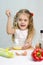 Girl playing in a cook churn whisk the eggs in a glass bowl