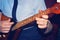 The girl is playing dombra and beating the chords on the guitar, close-up.