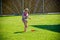 Girl playing with a garden sprinkler