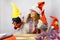 The girl is playing with homemade Christmas gnomes. A girl of 30-35 years old wearing a Santa Claus hat. Handmade Scandinavian