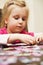 Girl playing with jigsaw puzzle