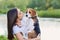 Girl playing kissing puppy beagle pet dog outdoor.