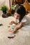 Girl playing observing toy bugs with a magnifying glass