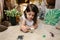 Girl playing observing toy bugs with a magnifying glass