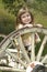 Girl playing on old wagon