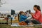 Girl playing patty-cake game with her nanny outdoors