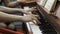 Girl is playing the piano. hands closeup