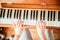 Girl is playing piano at home, high angle view, blurry background