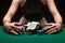 Girl playing poker and picks up her winnings with money and chips. Horizontal shot in a night game club. Casino Concept, Player,