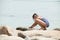 Girl playing on a rocky beach