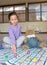 Girl Playing Snakes and Ladders with Teddy Bear.