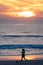 Girl playing soccer at sunset, Carcavelos beach, Lisbon, Portugal