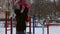 Girl playing on the sports playground in winter