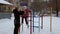 Girl playing on the sports playground in winter