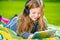 Girl Playing Tablet in a Park