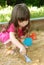 The girl playing to a sandbox