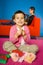 Girl playing with toy blocks (mother behind her)